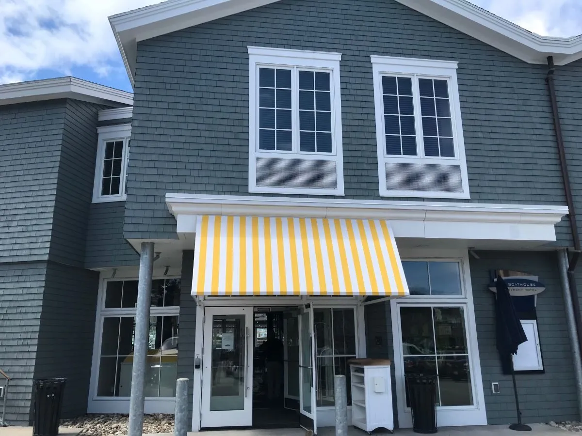 Yellow and White stripped awning over business entrance
